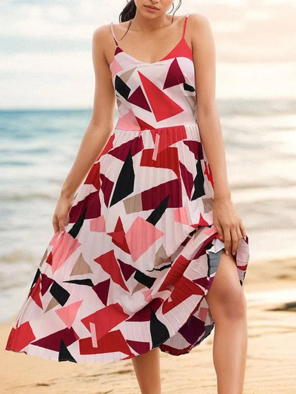Woman wearing a colorful geometric print midi dress from GUOCALI on a beach